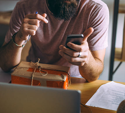 person using phone while shipping